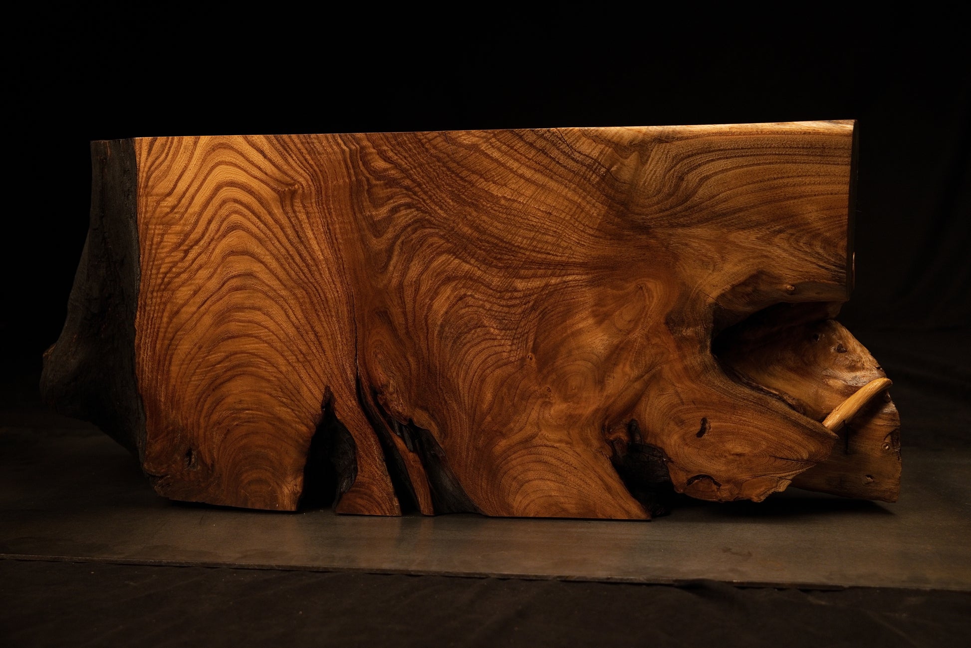 Perspective orientation of the heavy wooden root block displaying intricate sculptural contours and fluid grain flow.  