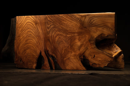Direct side elevation highlighting rippling wood grain formations and a prominent organic side cavity on the block.  
