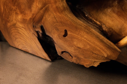 Close angle of the lower sculptural curve featuring an organic dark cavity resting directly against a metal base plate.  