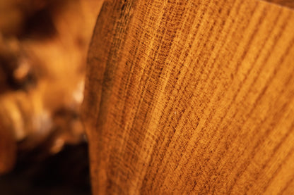 Uniform vertical golden wood grain runs cleanly across the precision-milled face of a heavy architectural timber.  