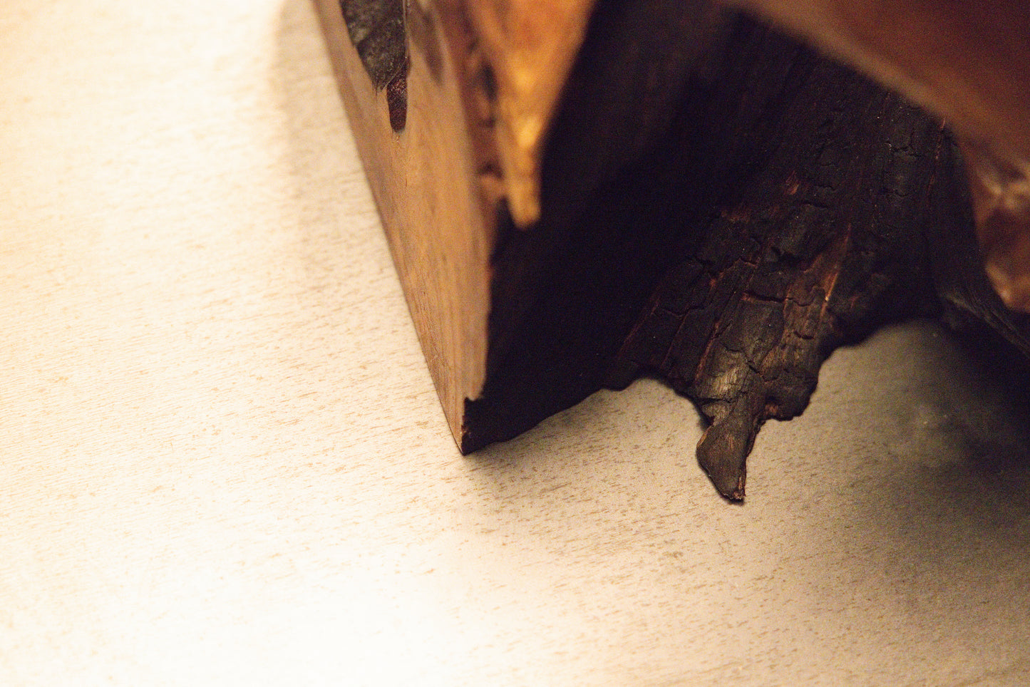 Close-up perspective of a solid structural wooden block corner revealing intricate grain direction and coloration. 