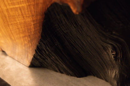 Detailed close-up perspective of a polished wooden block edge displaying fine grain patterns and a natural indent. 