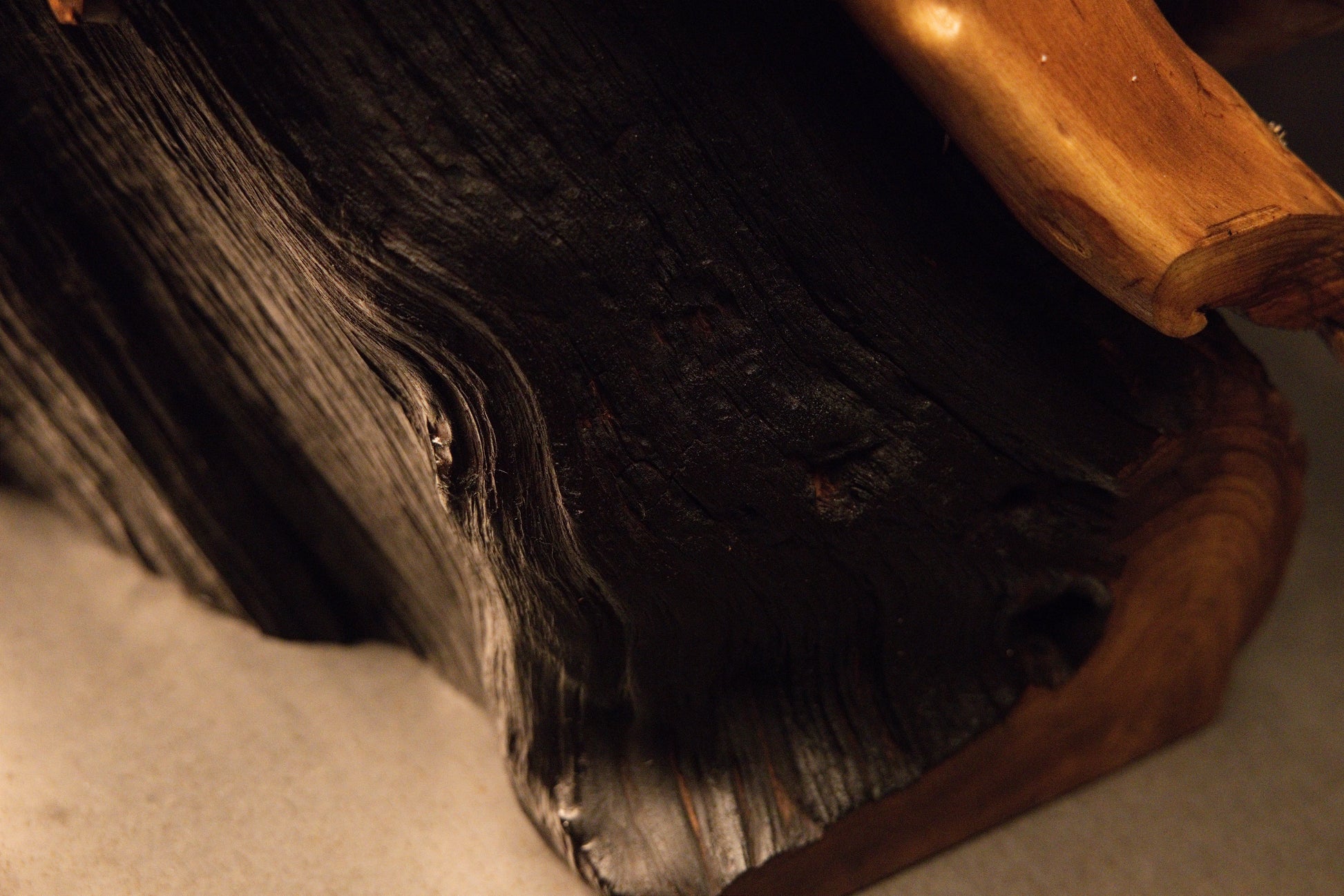 Detailed close-up view of a rounded wooden element featuring clean growth rings and a smooth polished finish. 