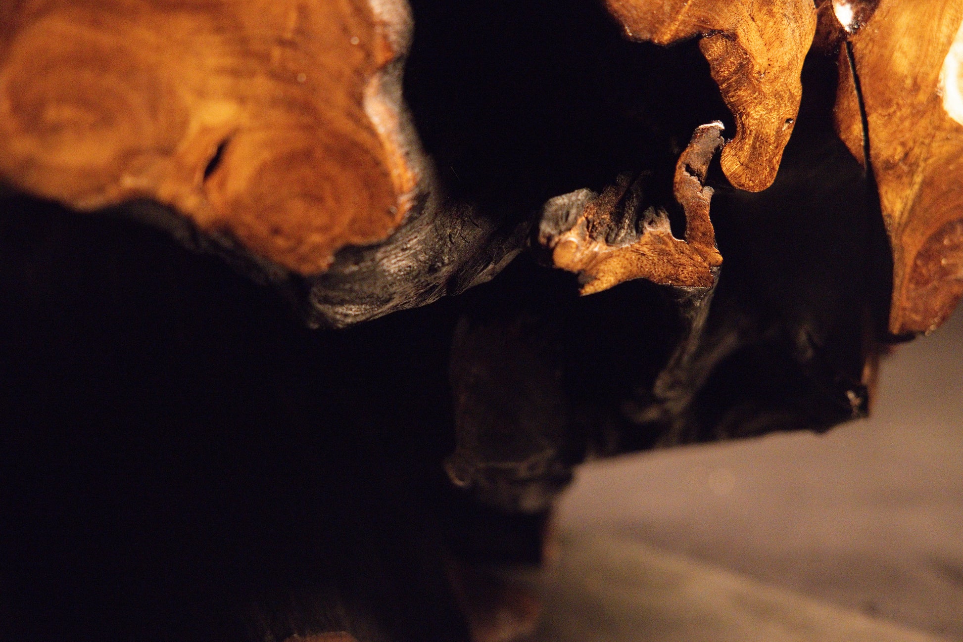 Detailed macro photograph showing uniform vertical grain orientation and warm amber wood tones on the furniture piece. 