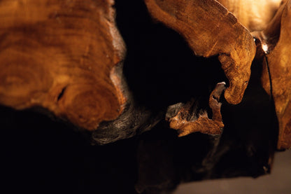 Detailed close-up view of a natural wood surface featuring rich amber color variations and subtle details. 